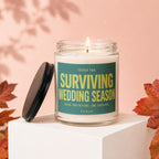 Scented candle with text "Surviving Wedding Season: Seven Invitations. One Survivor."