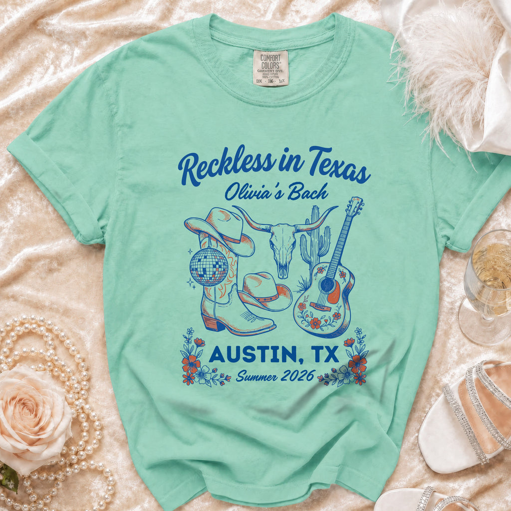Mint t-shirt with "Reckless in Texas Olivia's Bach Austin, TX Summer 2026" graphic.