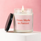 Scented candle with a pink label that reads "From Maybe to Forever. VOWED".