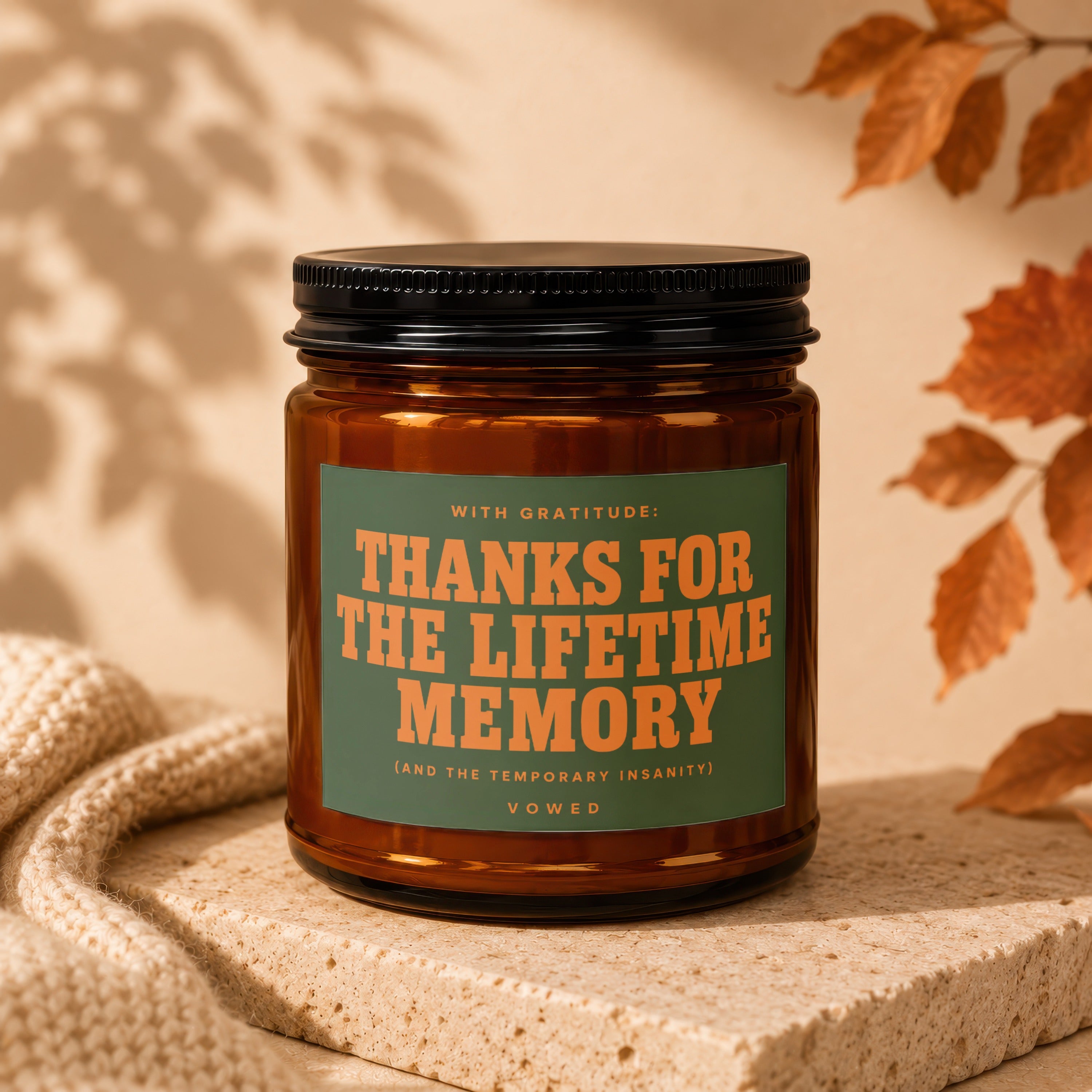 Amber candle with green label saying "Thanks for the Lifetime Memory" vowing.