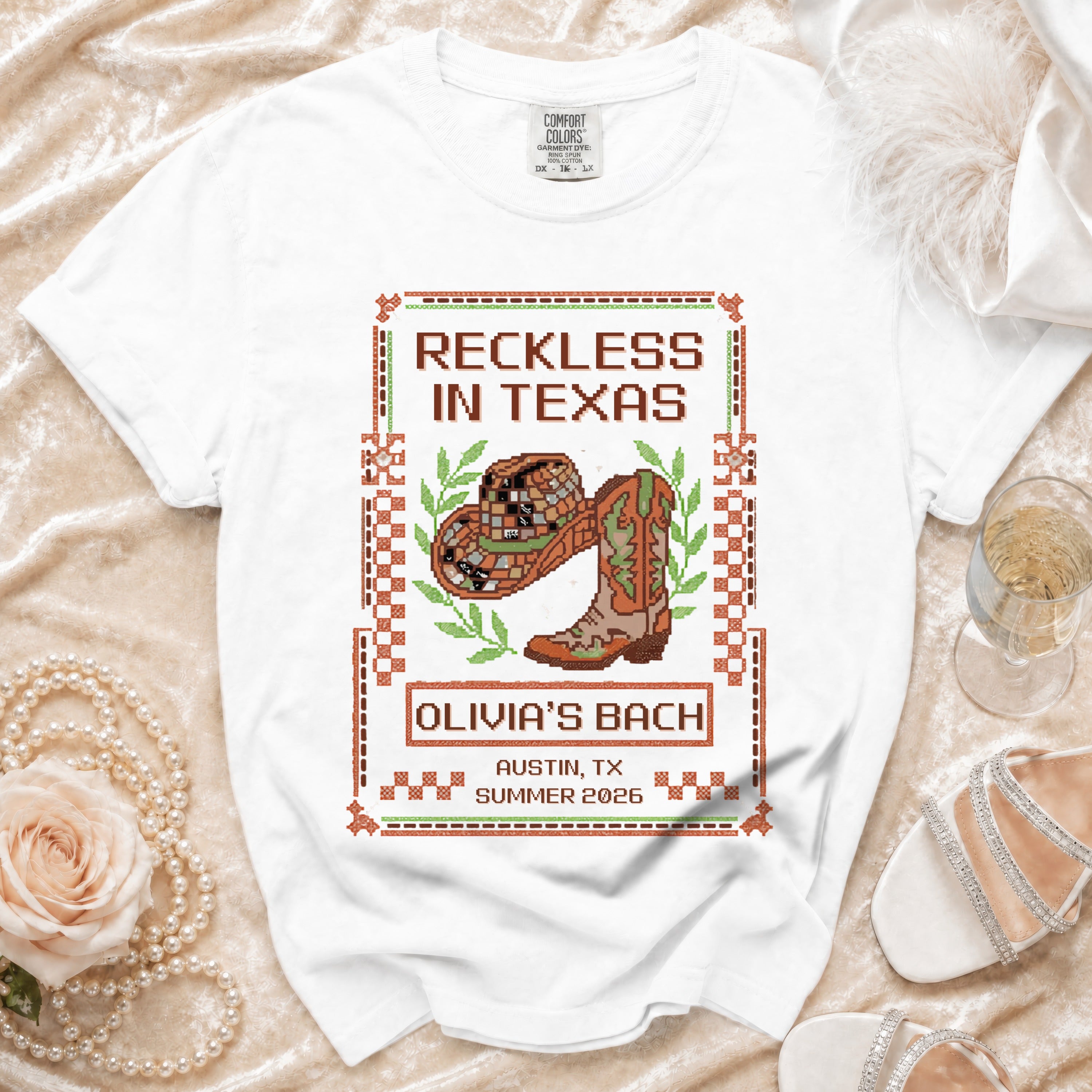 White t-shirt with "Reckless in Texas" graphic for Olivia's Bach.