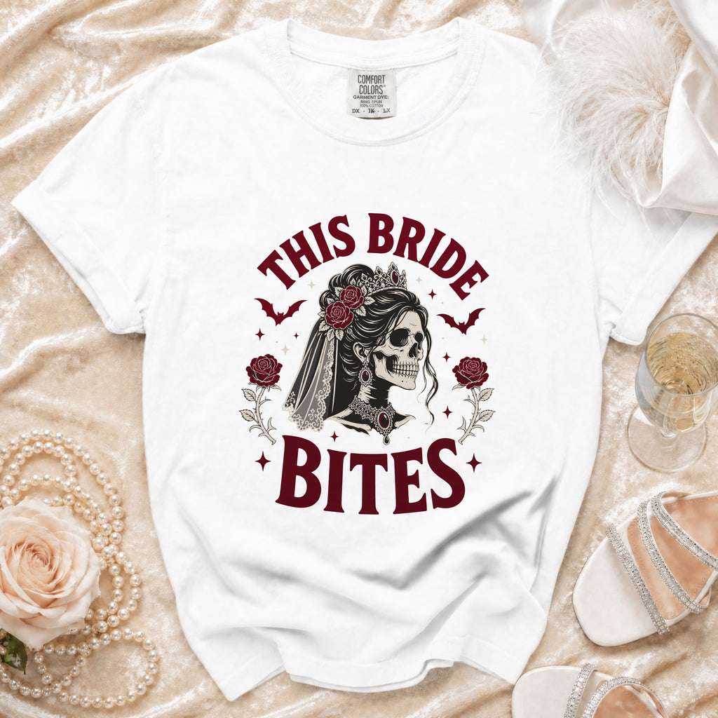 White t-shirt with "This Bride Bites" text and gothic skeleton bride graphic.