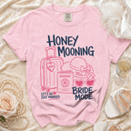 Pink t-shirt with "Honey Mooning Bride Mode" text and travel icons.