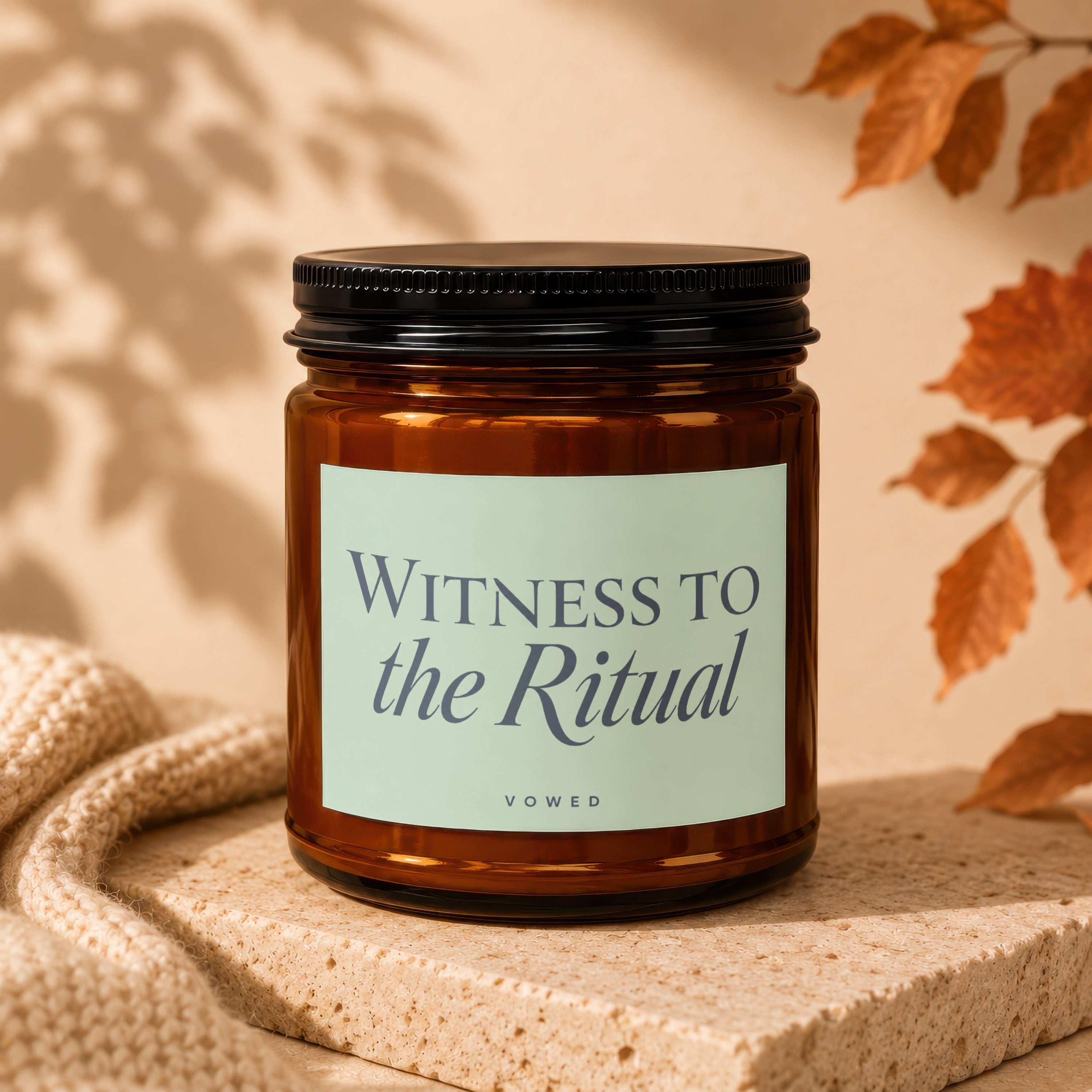 Amber glass candle with "Witness to the Ritual" and "Vowed" text on label.