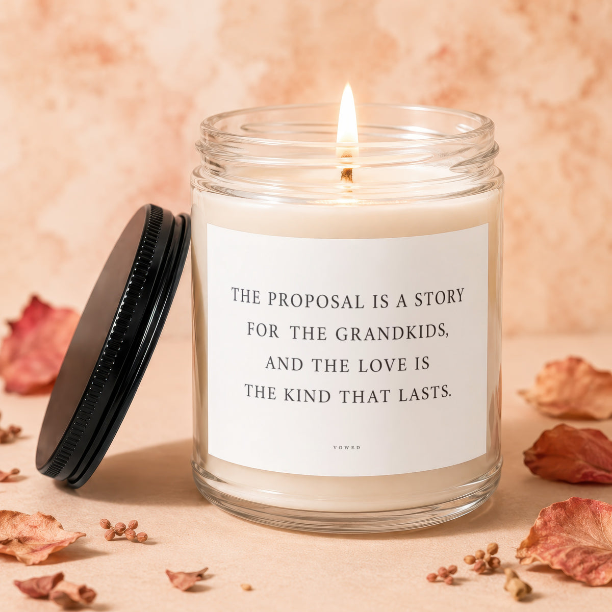 Lit candle in glass jar with lid, quoting "The proposal is a story for the grandkids".