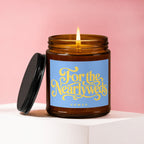 Amber glass candle with burning wick and "For the Newlyweds VOWED" label.