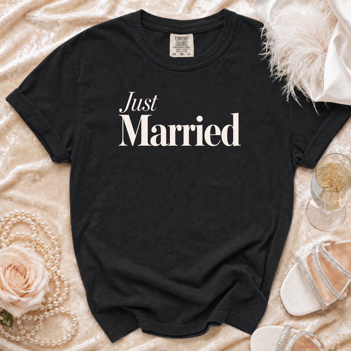 Black t-shirt with "Just Married" printed in cream text.