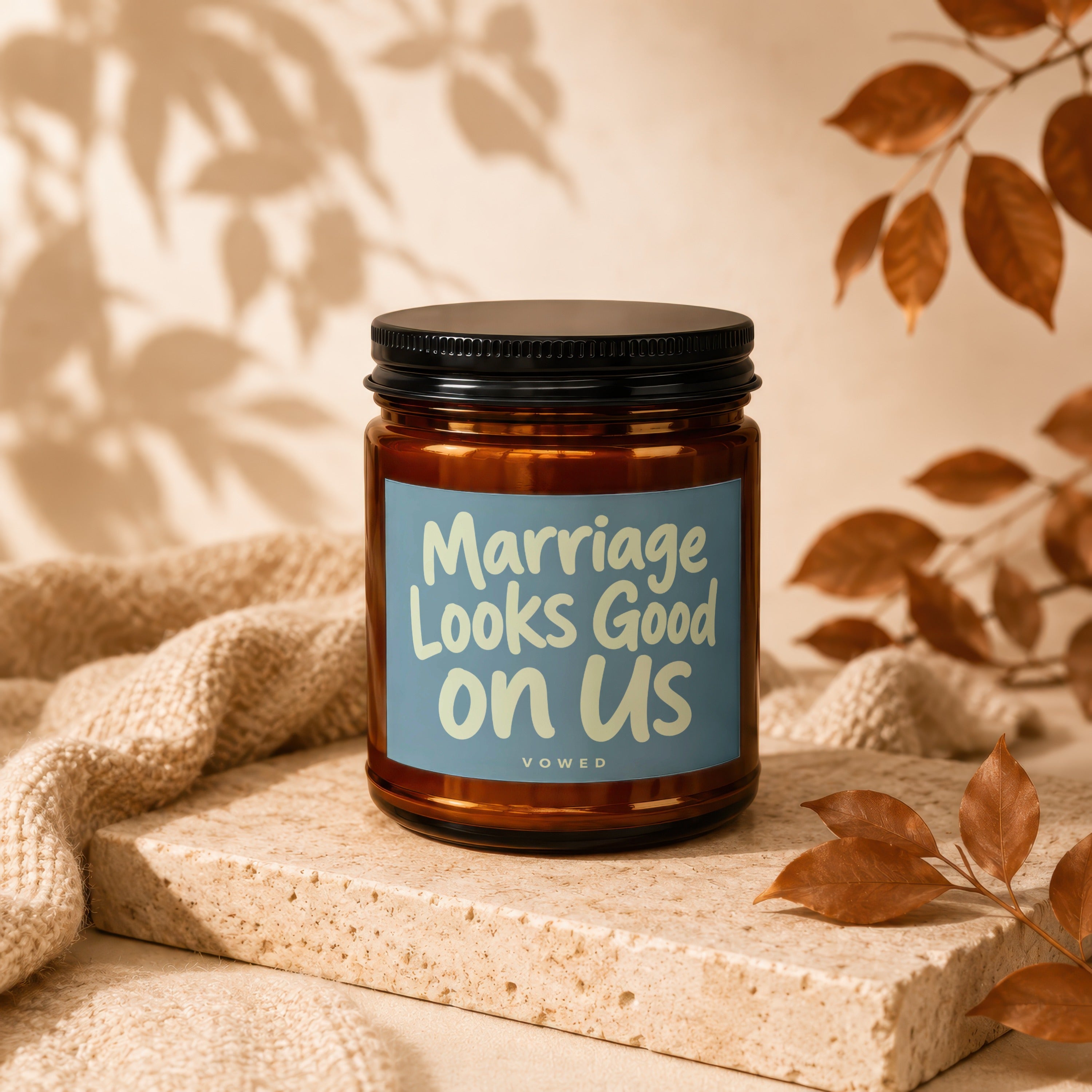 Glass jar candle with blue label reading "Marriage Looks Good on Us"