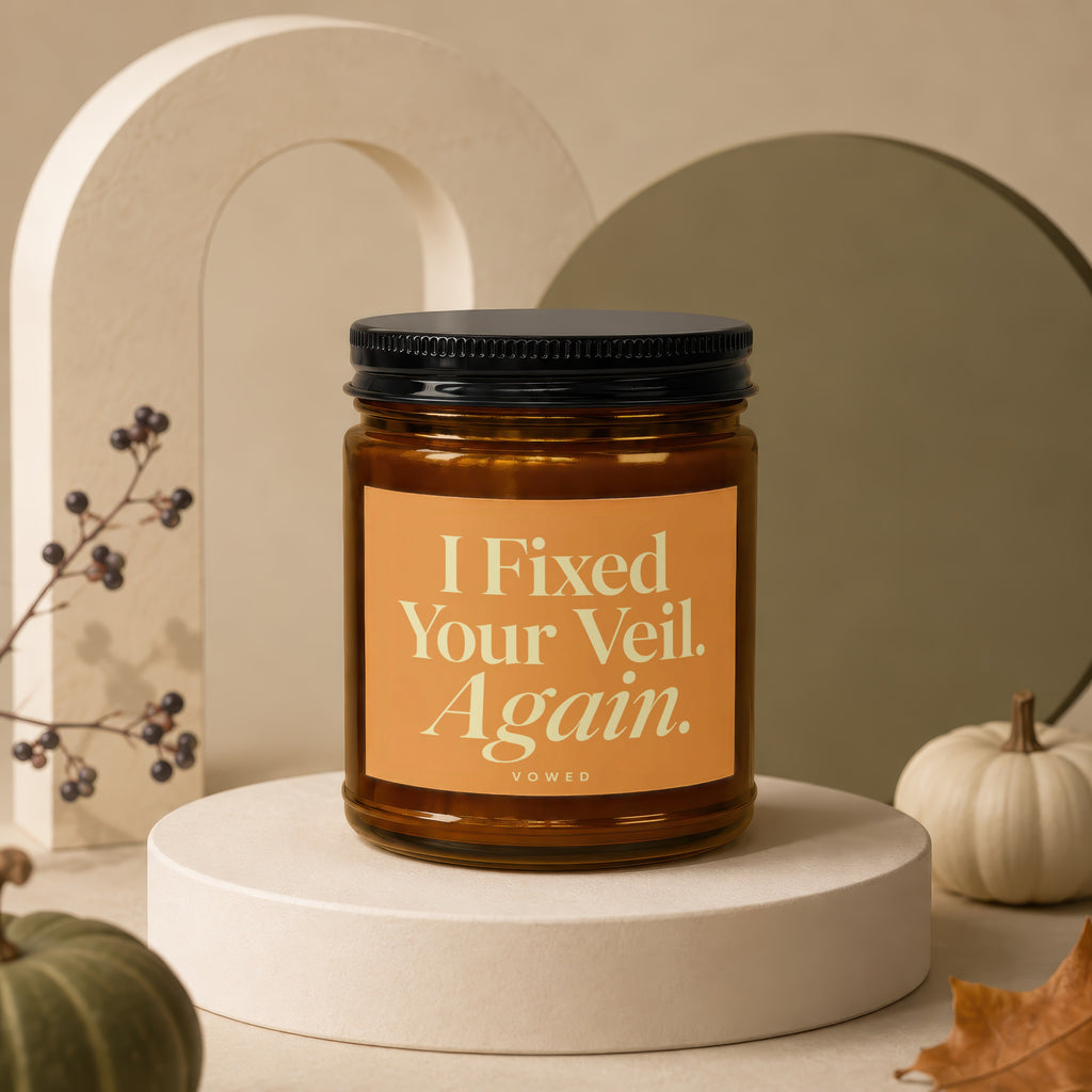 Amber jar candle with black lid labeled "I Fixed Your Veil. Again."