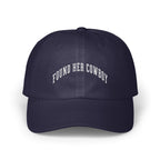 A navy blue baseball cap embroidered with the white arched text FOUND HER COWBOY.