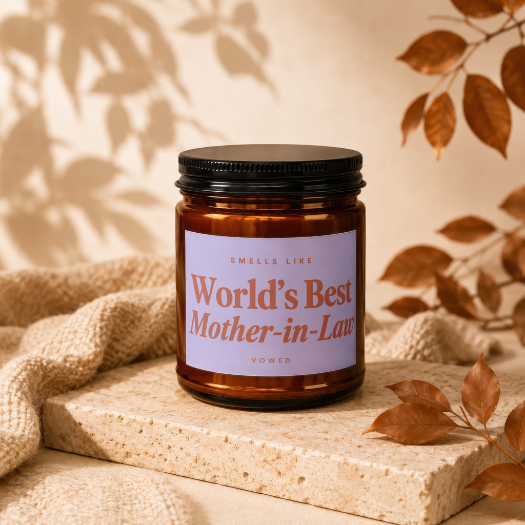 Amber jar candle with lavender label reading "Smells Like World's Best Mother-in-Law".