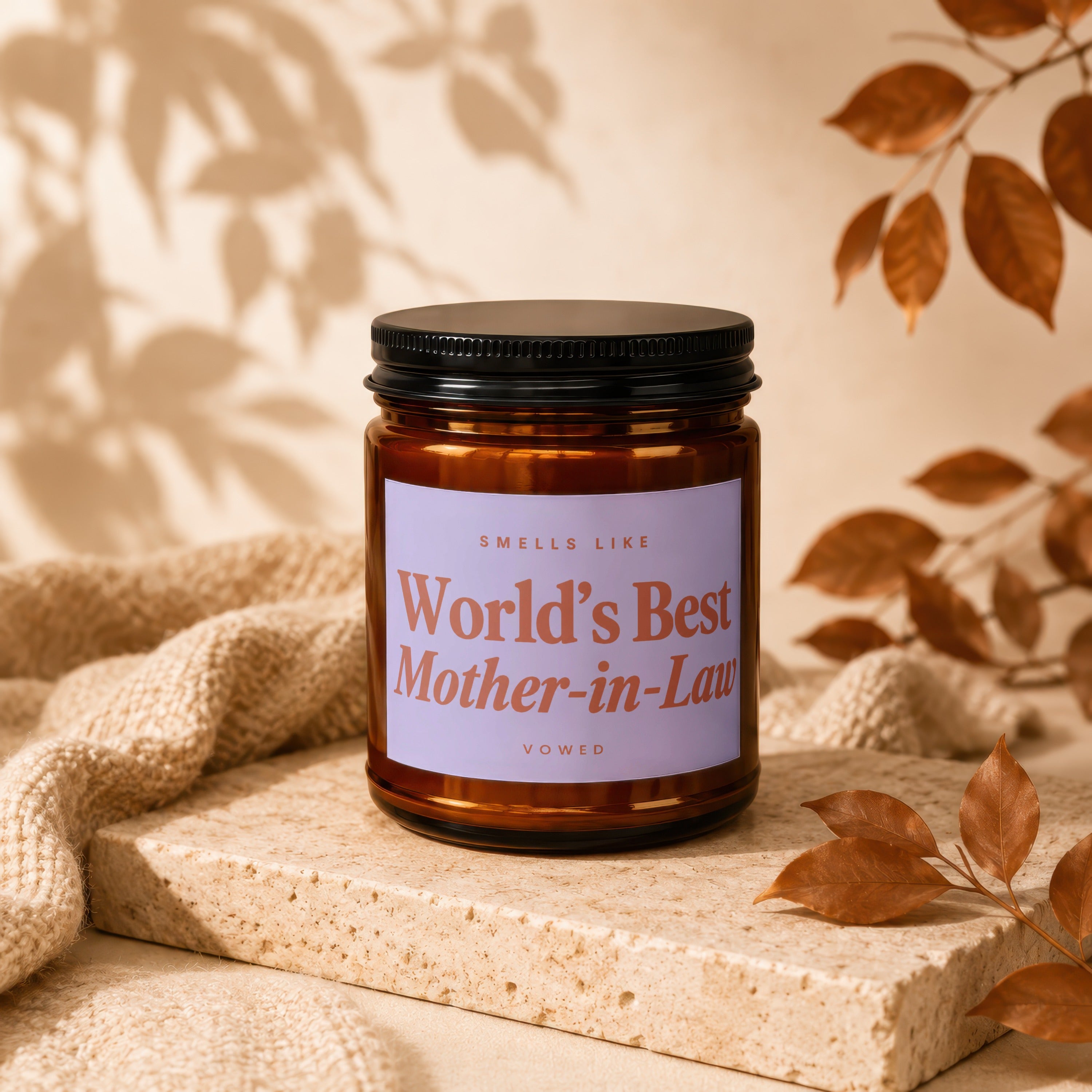 Amber jar candle with lavender label reading "Smells Like World's Best Mother-in-Law".