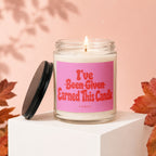 Glass candle with pink label reading "I've Been Given Earned This Candle".