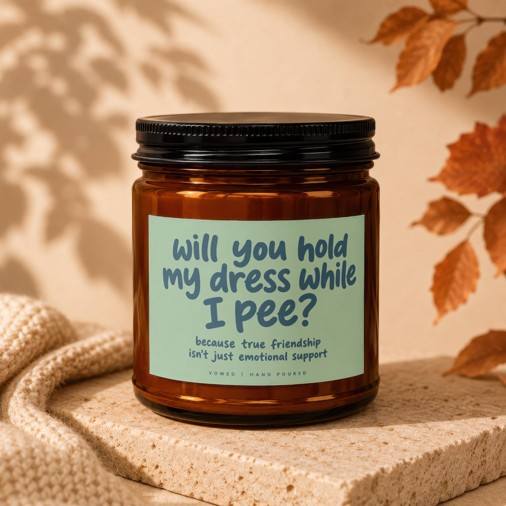 Candle with text: "Will you hold my dress while I pee? because true friendship isn't just emotional support."