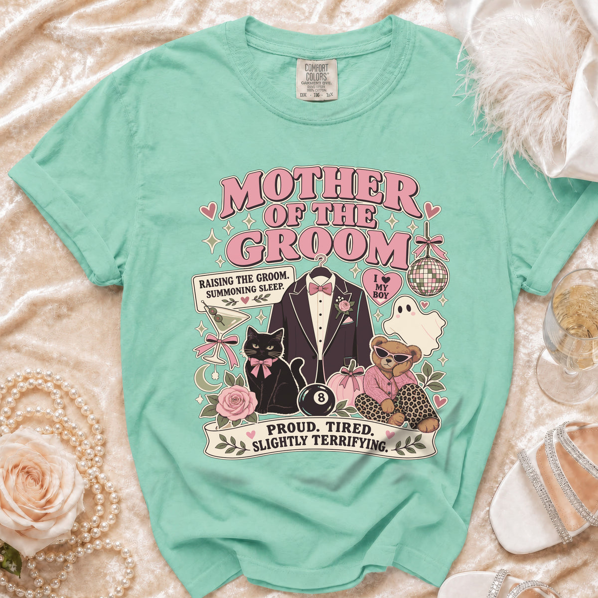 Mother of the Groom graphic tee with tuxedo, black cat, teddy bear, and text.