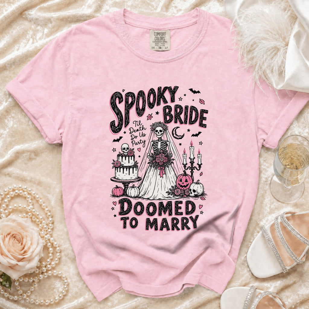 Pink t-shirt with "Spooky Bride Doomed to Marry" graphic featuring a skeleton bride.