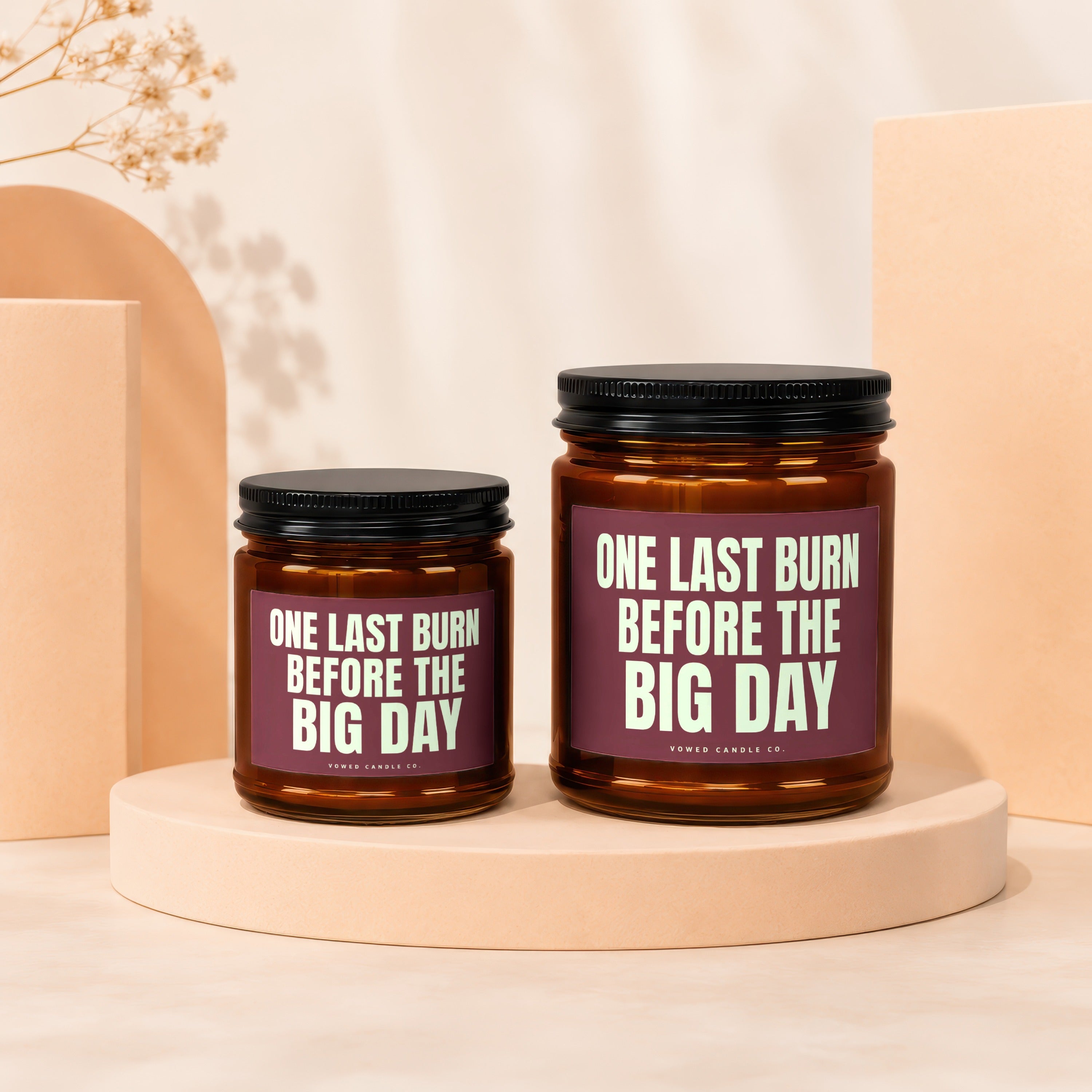 Two amber glass candles with black lids, labeled "One Last Burn Before the Big Day".