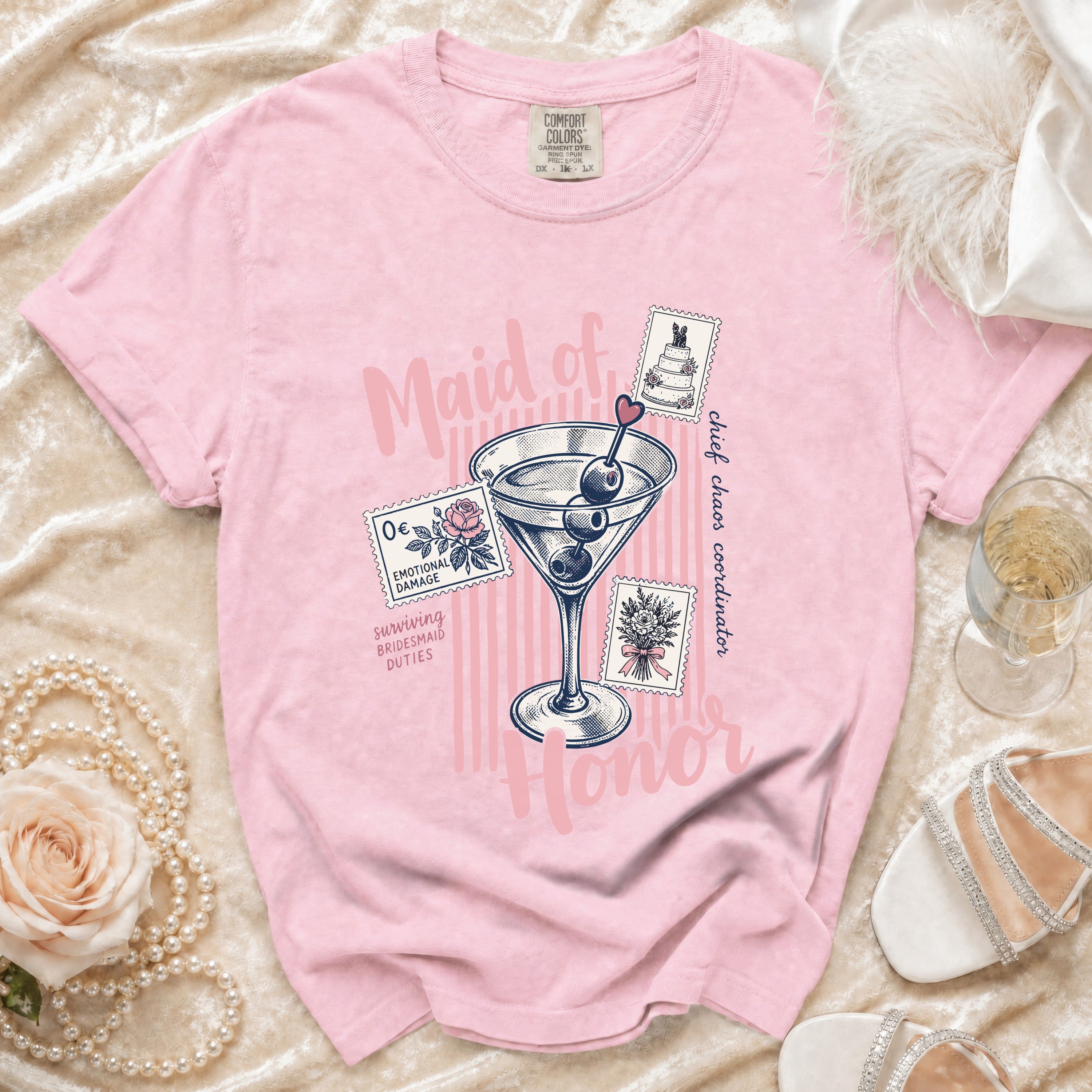 Pink t-shirt with "Maid of Honor" text, martini glass, and stamps.