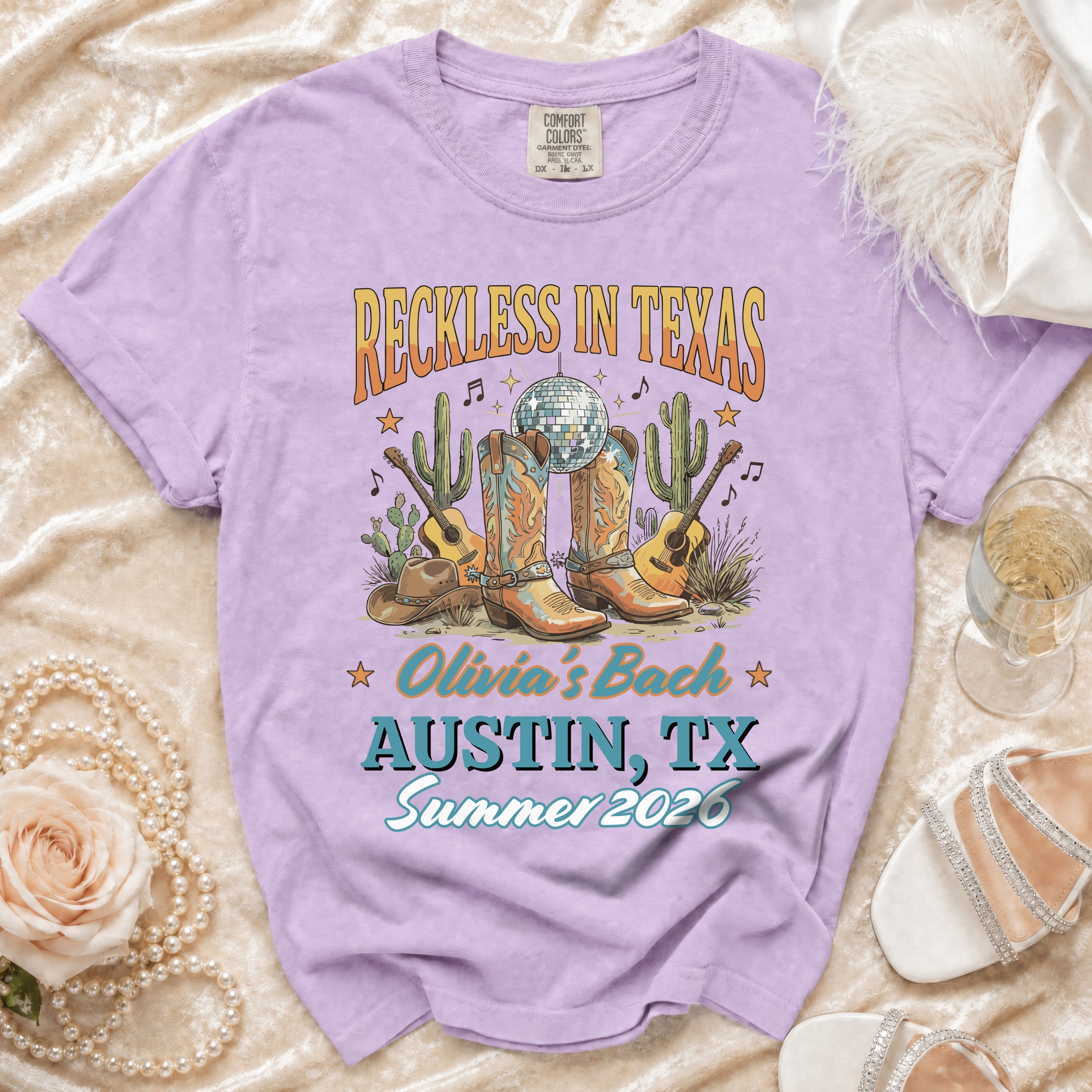 Purple t-shirt with "Reckless in Texas" and Austin concert details.