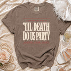 Brown t-shirt with "Til Death Do Us Party" text, featuring "A Cautionary Tale in One Act" and "No Survivors, No Refunds, No Regrets."