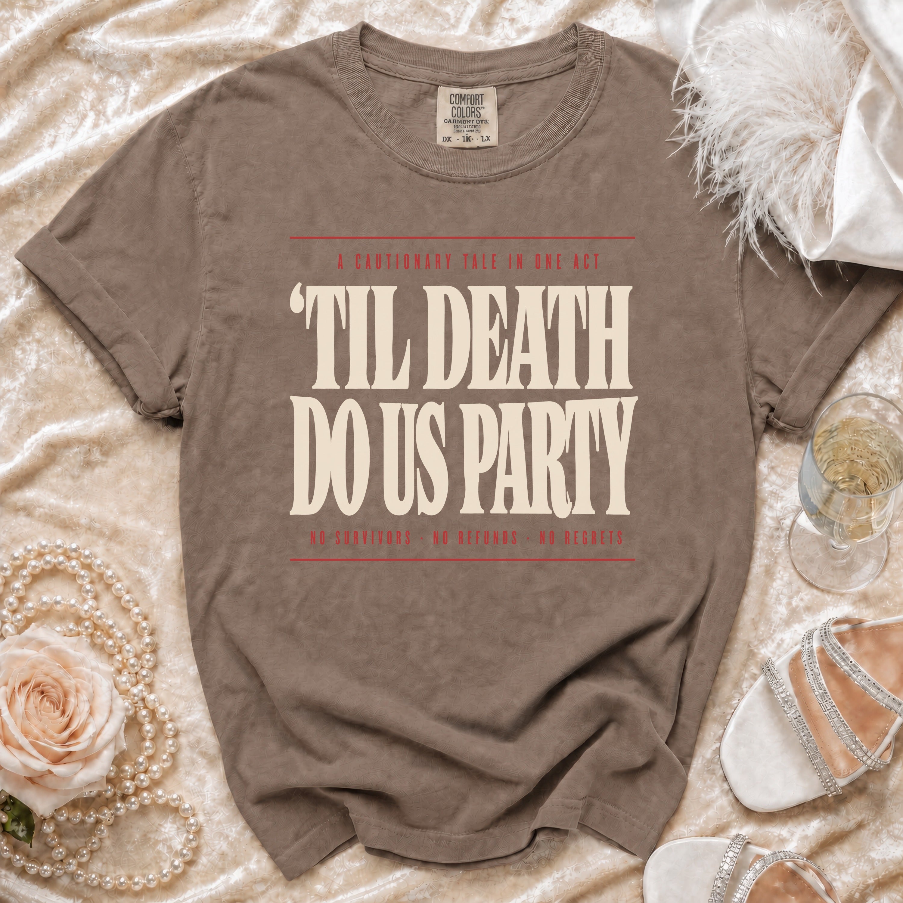 Brown t-shirt with "Til Death Do Us Party" text, featuring "A Cautionary Tale in One Act" and "No Survivors, No Refunds, No Regrets."