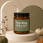 Amber candle with "New Ring, Who Dis? Excuse The Sparkle" text on a green label.