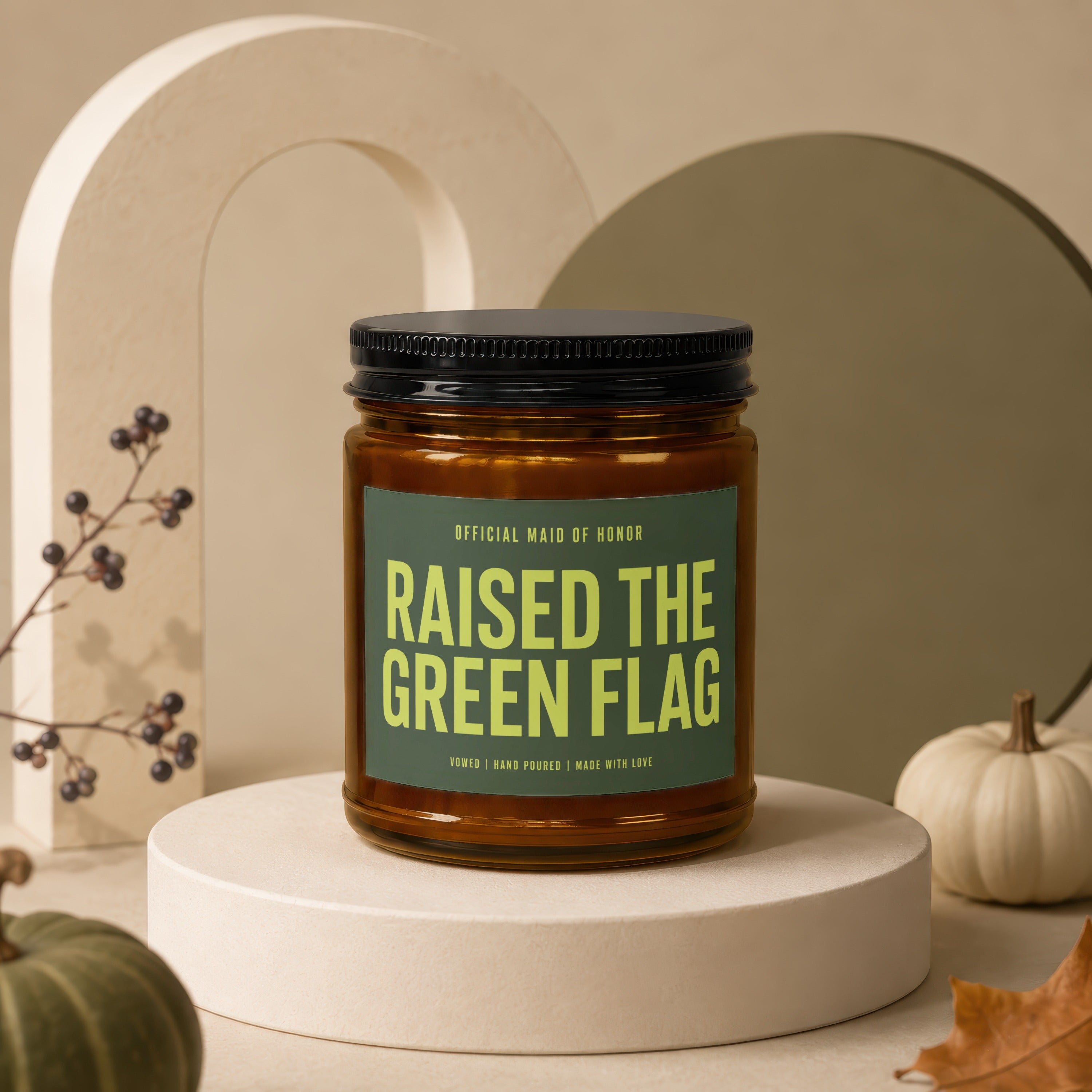 Amber jar candle with green label reading "Raised The Green Flag".