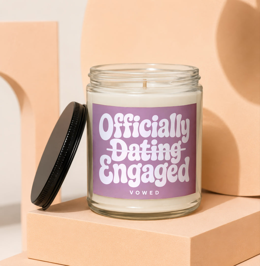 Jar candle with "Officially Dating Engaged" text on a purple label.