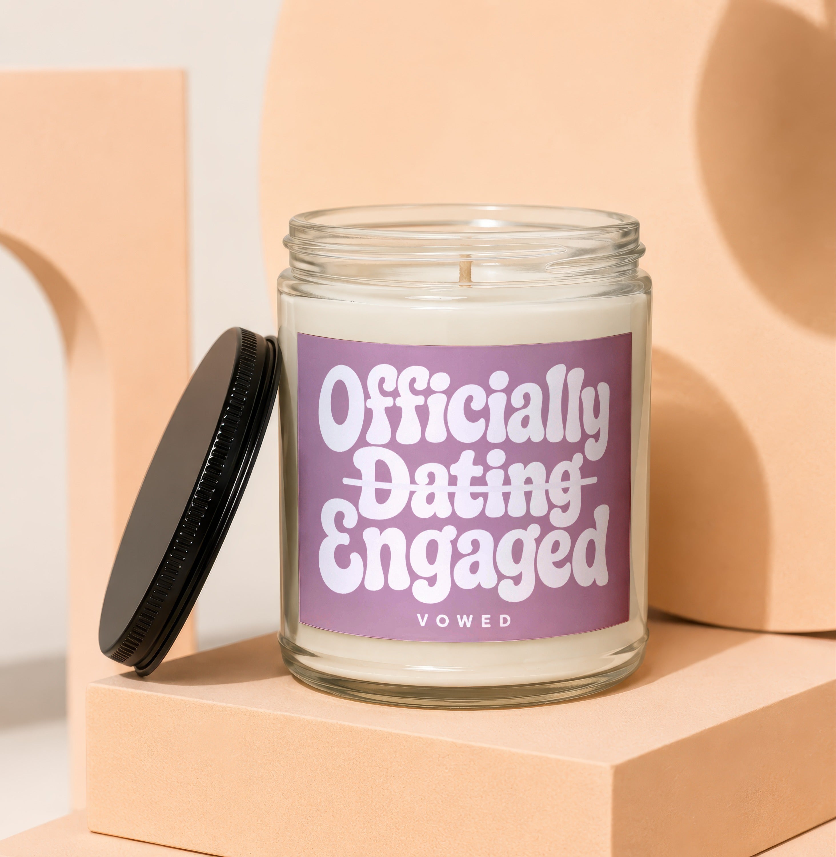 Jar candle with "Officially Dating Engaged" text on a purple label.
