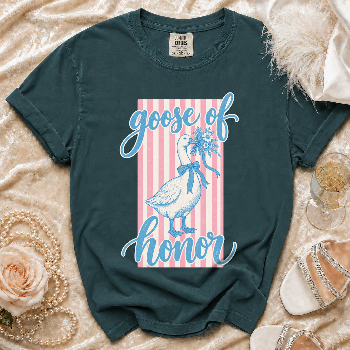 Green t-shirt with a goose holding flowers and text "goose of honor".