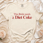 Cream t-shirt with red text reading "This Bride needs a Diet Coke".