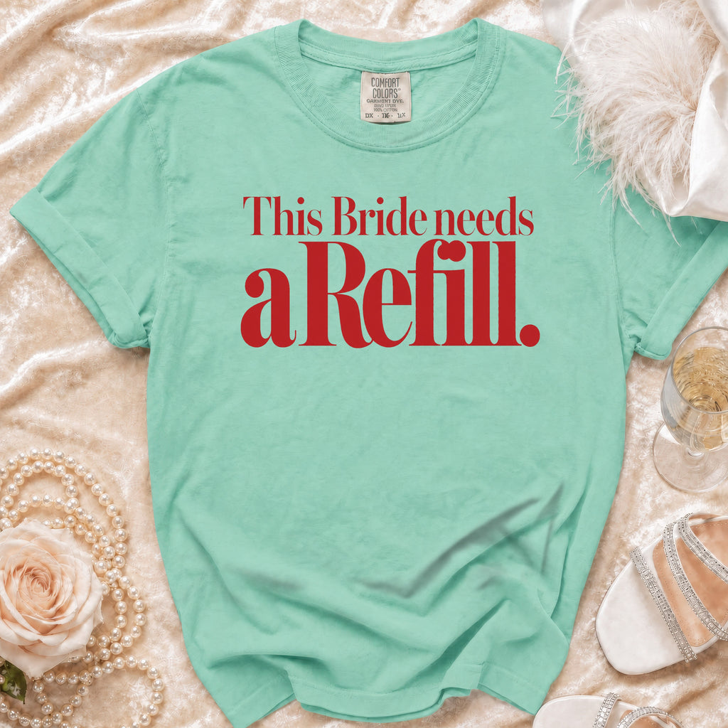 Green t-shirt with red text that reads "This Bride needs a Refill."