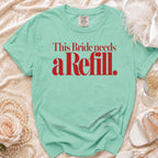 Green t-shirt with red text that reads "This Bride needs a Refill."