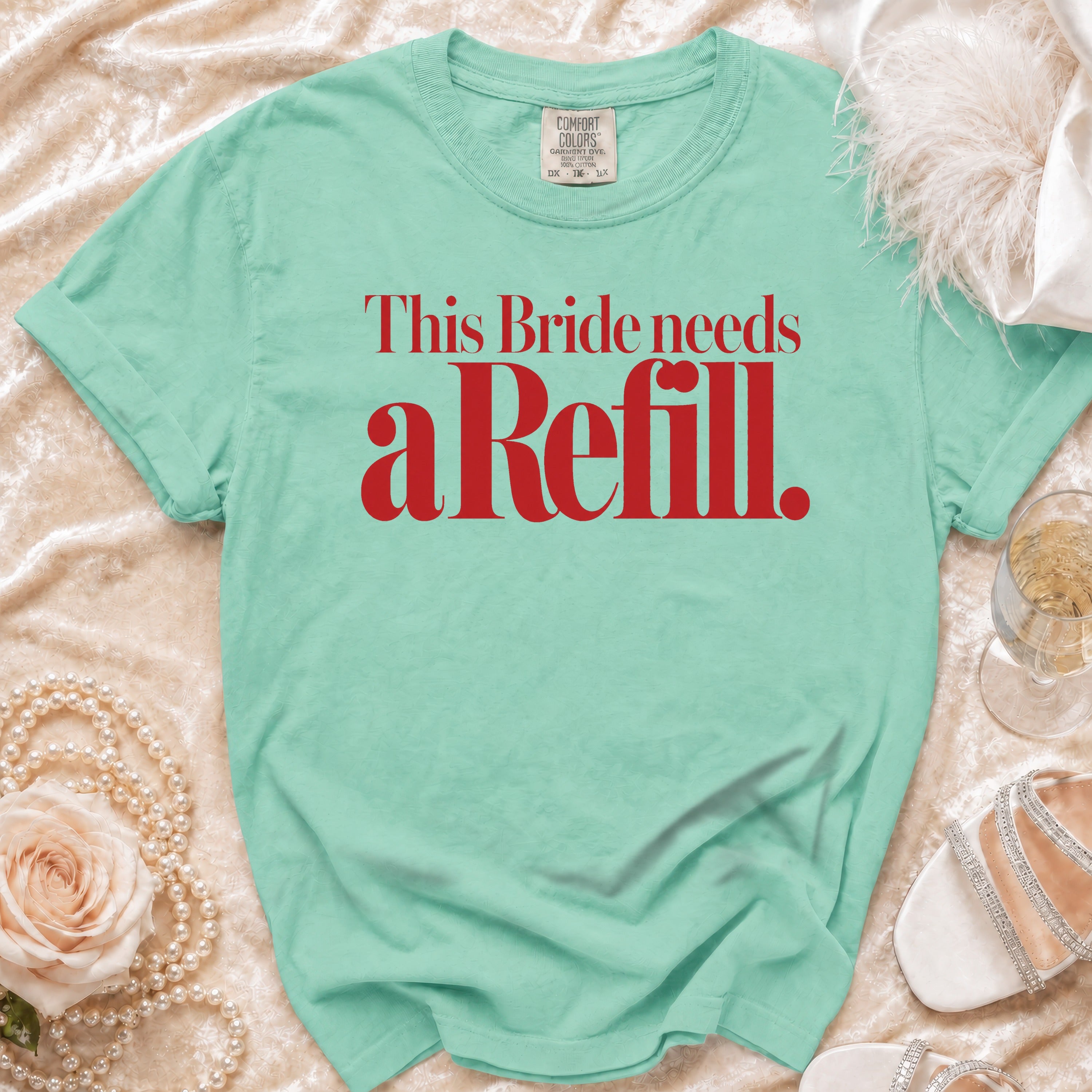 Green t-shirt with red text that reads "This Bride needs a Refill."