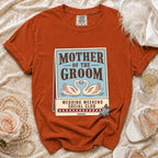 Orange t-shirt with "Mother of the Groom Wedding Weekend Social Club" graphic.