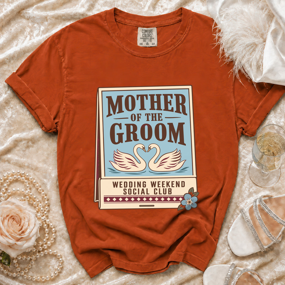 Orange t-shirt with "Mother of the Groom Wedding Weekend Social Club" graphic.
