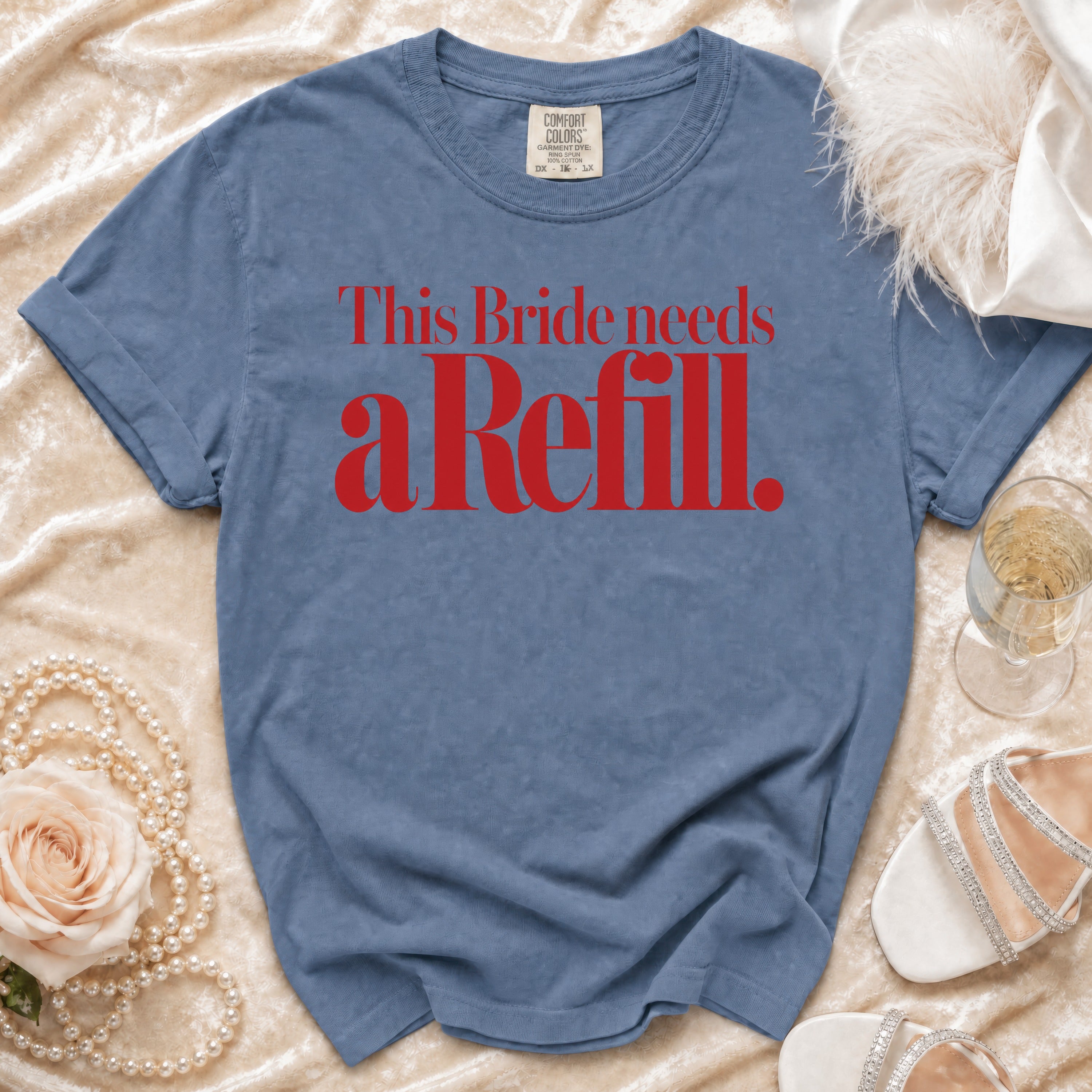 Blue t-shirt with red text "This Bride needs a Refill."