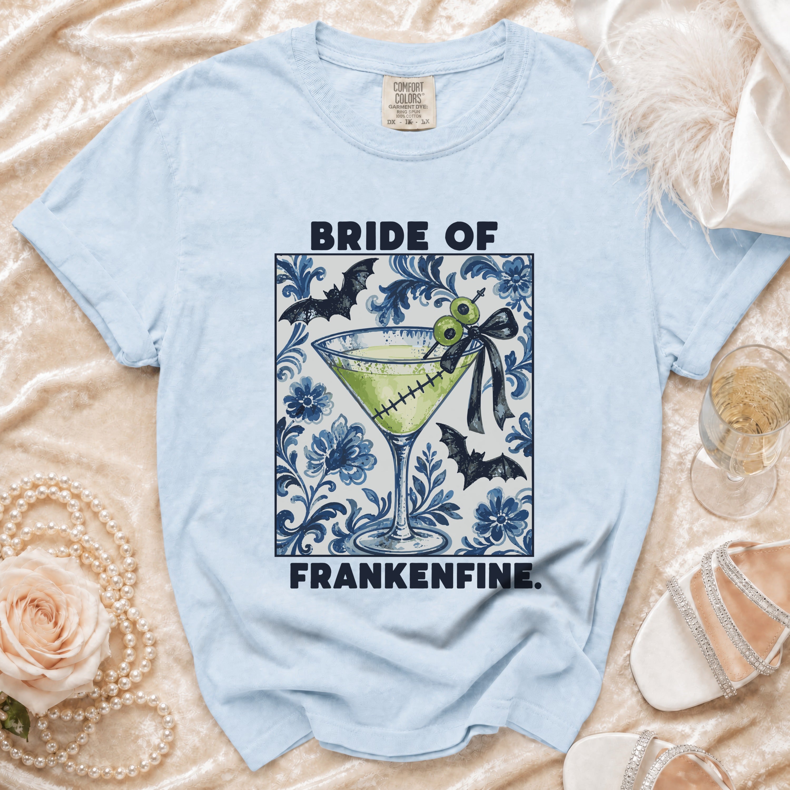 Light blue t-shirt with "Bride of Frankenfine" text and a cocktail graphic.