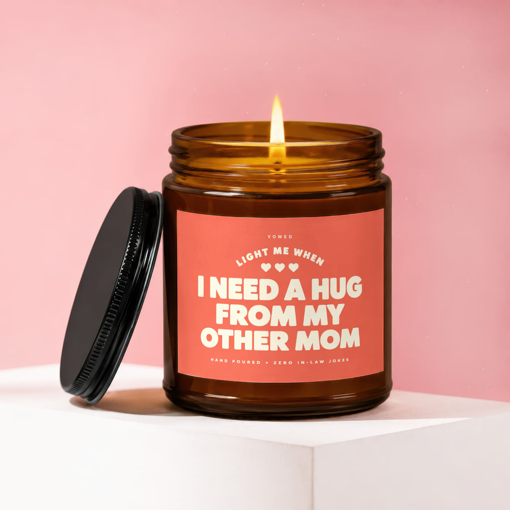 Amber jar candle with pink label reading "Light me when I need a hug from my other mom".