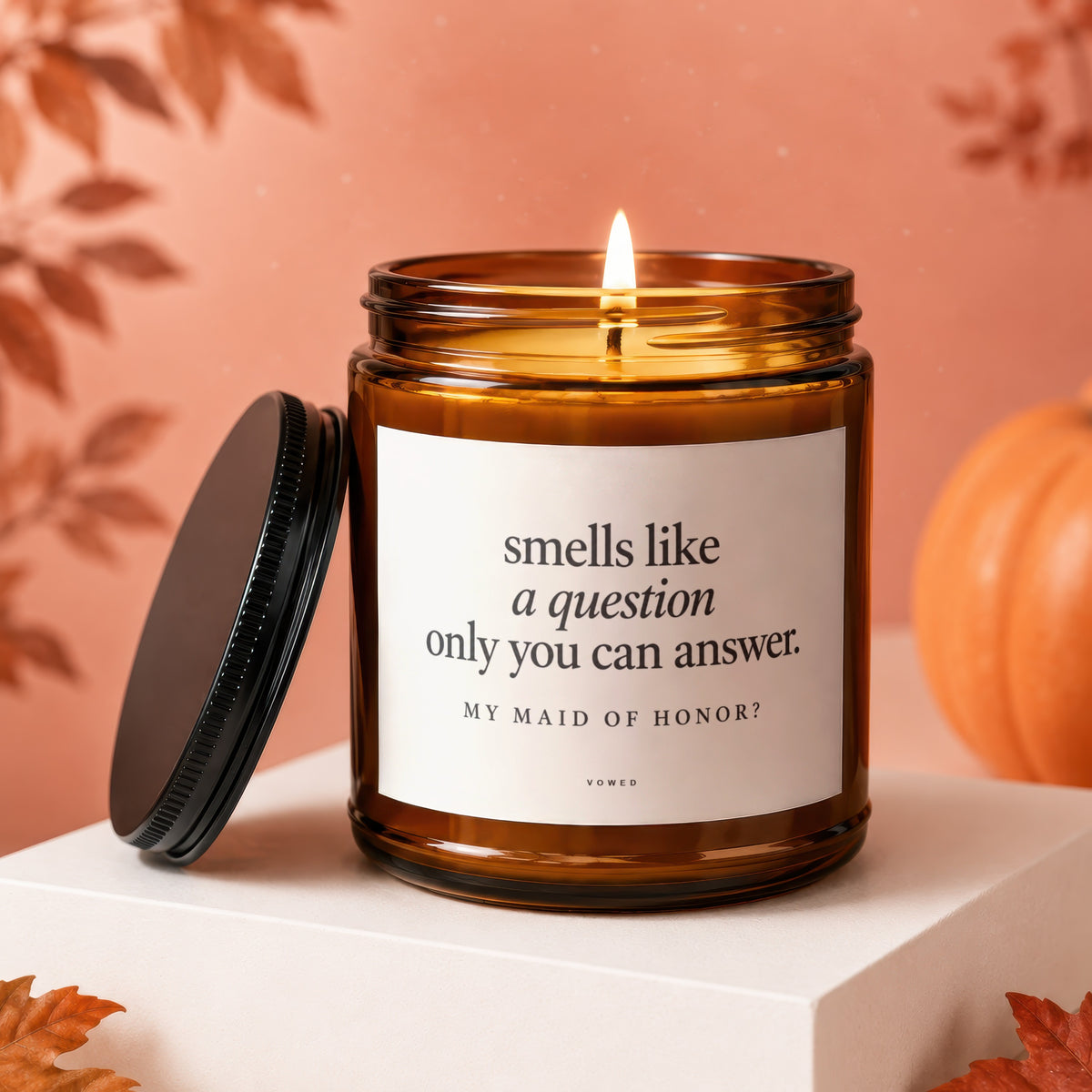Amber candle with lid off, reading "smells like a question only you can answer. MY MAID OF HONOR?".