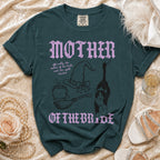 Dark green t-shirt with "MOTHER OF THE BRIDE" text and witchy graphics.