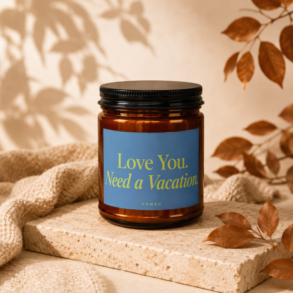 Amber candle with blue label reading "Love You. Need a Vacation."