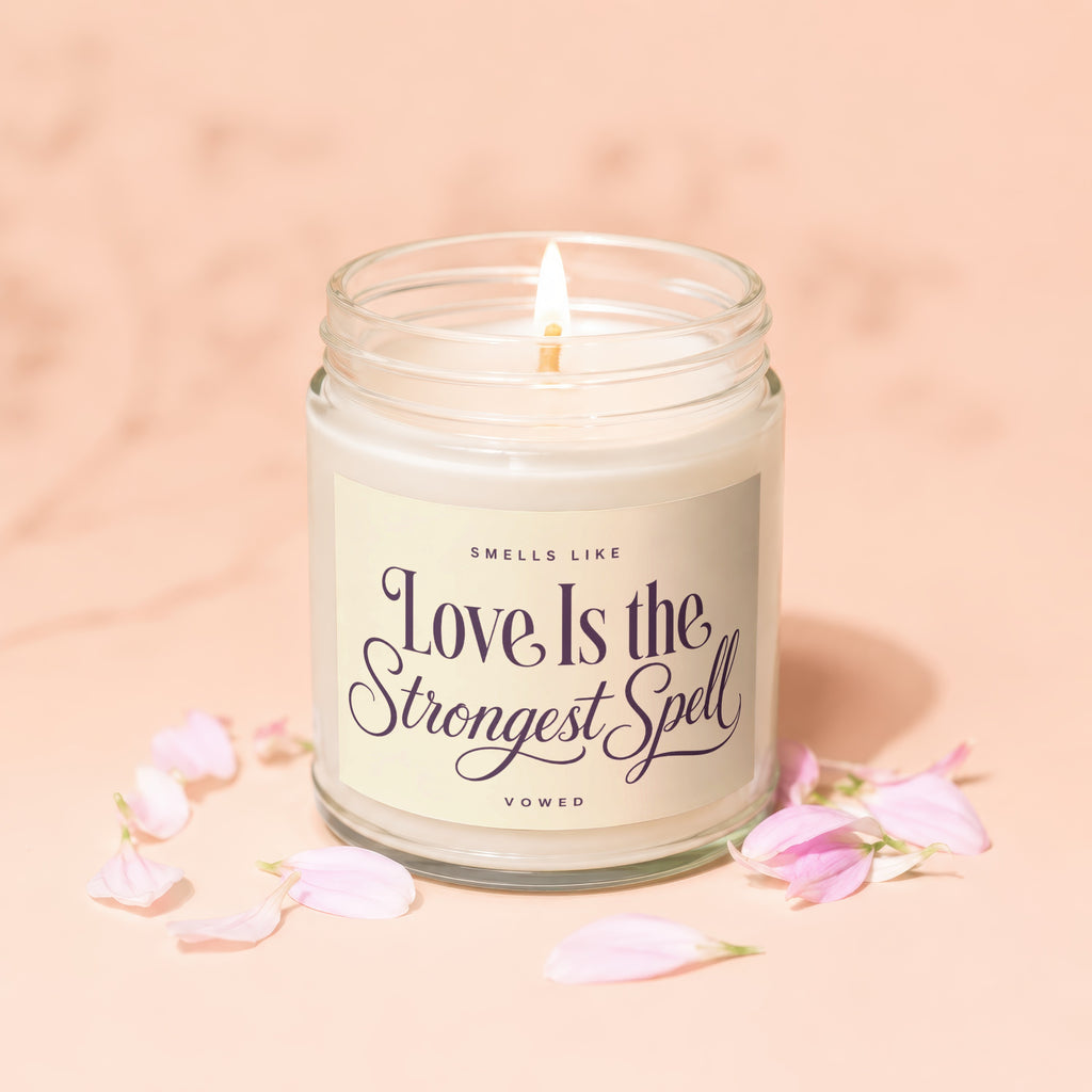 Candle with label reading "Smells Like Love Is the Strongest Spell Vowed".