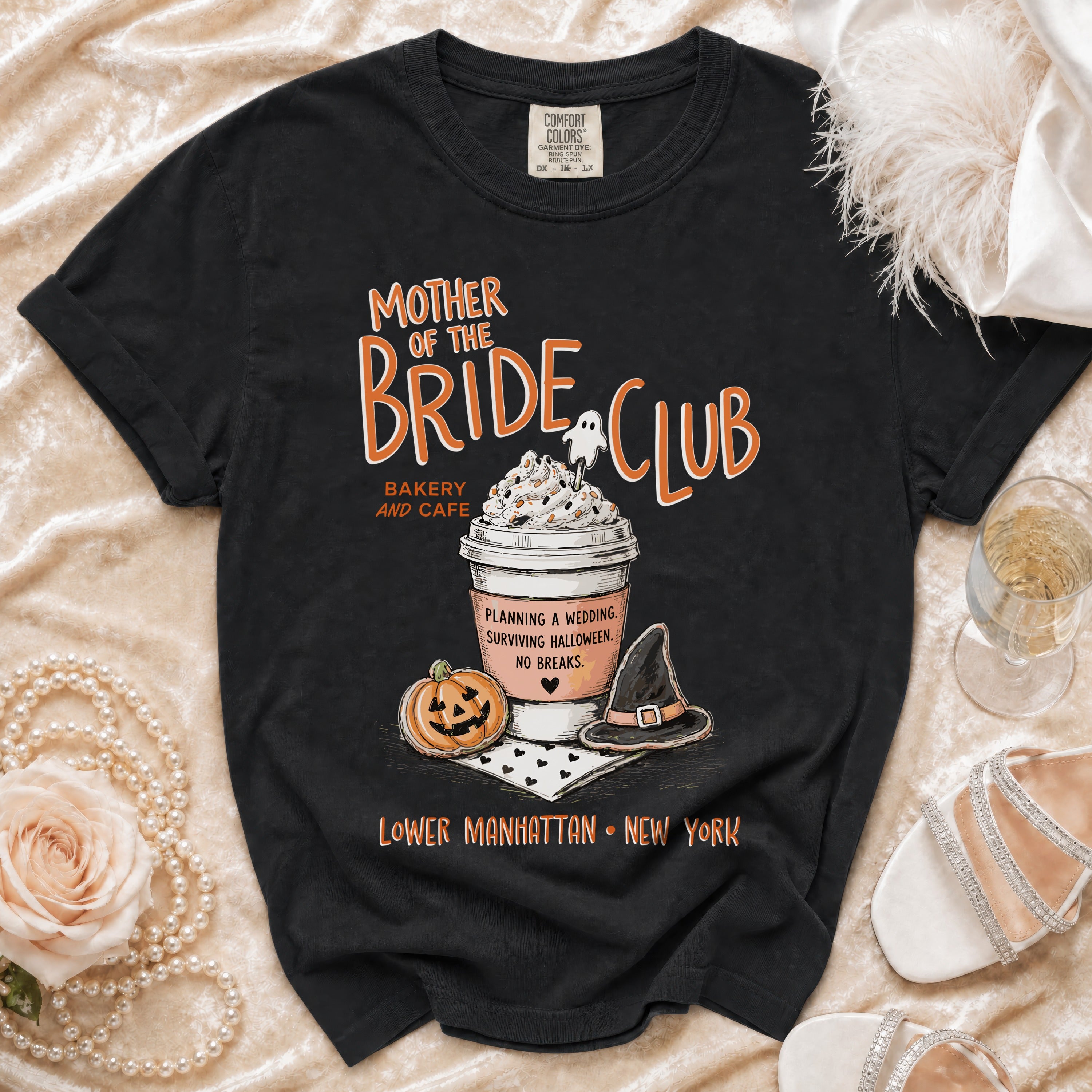 Black t-shirt with "Mother of the Bride Club" graphic, coffee cup, pumpkin, and witch hat.