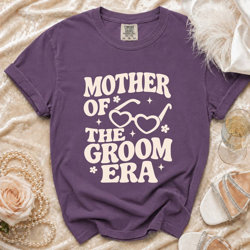 Purple t-shirt with "Mother of the Groom Era" text and heart-shaped glasses graphic.