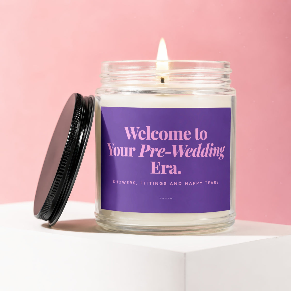 Lit candle with purple label reading "Welcome to Your Pre-Wedding Era."