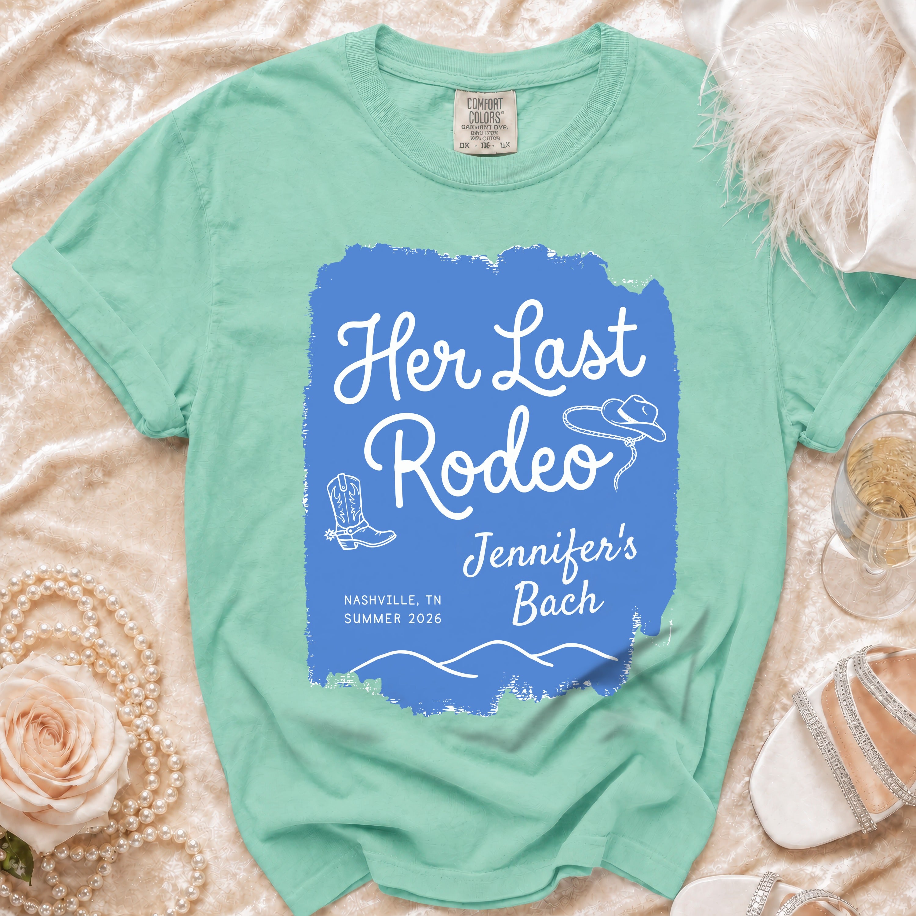 Comfort Colors t-shirt with "Her Last Rodeo" text, cowboy hat, and boots.