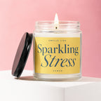 Lidded glass candle with yellow label reading "Smells Like Sparkling Stress Vowed".