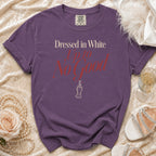 Purple t-shirt with "Dressed in White Up to No Good" text and crossed fingers graphic.