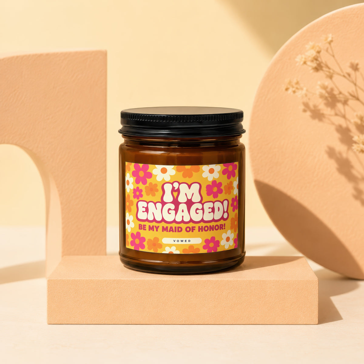 Amber jar candle with "I'm Engaged! Be My Maid of Honor!" text on floral label.